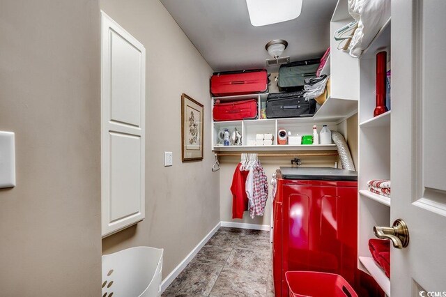 clothes washing area with baseboards