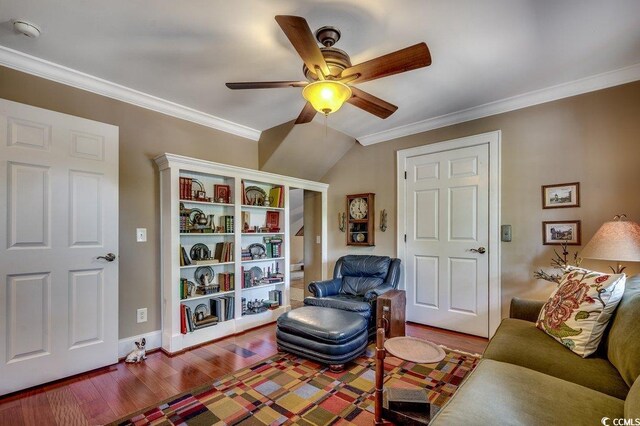 living room featuring ceiling fan, baseboards, wood finished floors, and crown molding