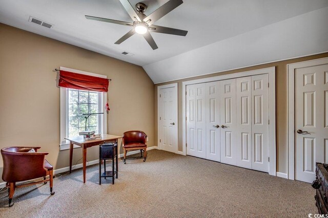 office area with visible vents, light colored carpet, and lofted ceiling