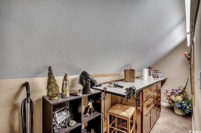 office area featuring baseboards, carpet, and vaulted ceiling