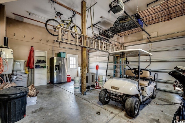 1539 Old Town Ave, Georgetown, SC 29440 - garage with stainless steel refrigerator with ice dispenser and a garage door opener
