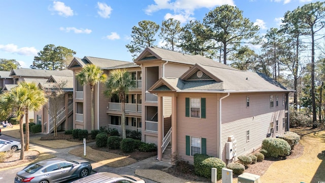 270 Pinehurst Ln Unit 9G, Pawleys Island, SC 29585 - view of building exterior with stairs and uncovered parking