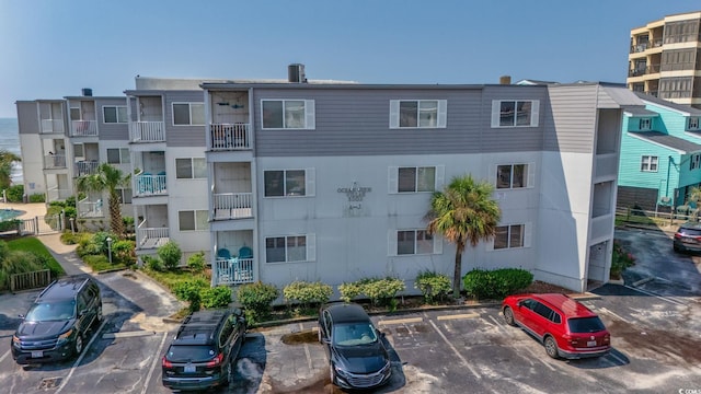 view of building exterior with uncovered parking