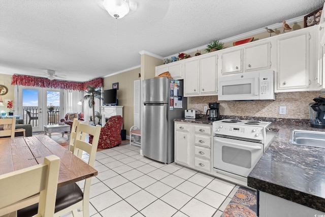 kitchen with white appliances, light tile patterned floors, ceiling fan, white cabinetry, and dark countertops