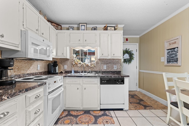 kitchen with a sink, white appliances, light tile patterned flooring, crown molding, and decorative backsplash