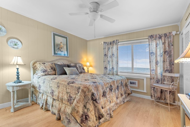 bedroom featuring ornamental molding, baseboards, ceiling fan, and wood finished floors