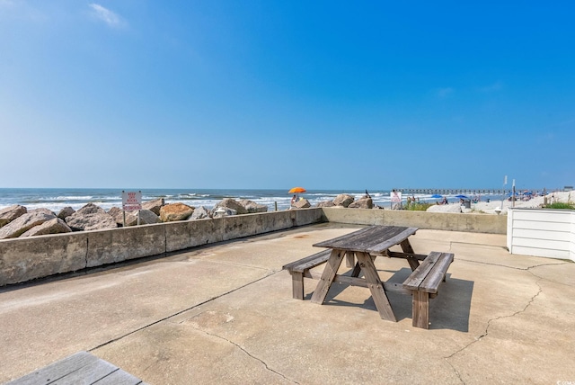 view of patio with a water view