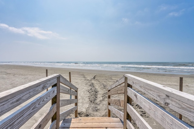 view of home's community featuring a view of the beach and a water view