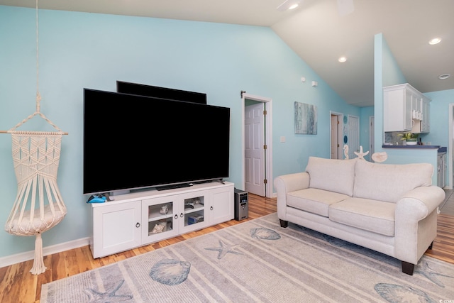 living room featuring recessed lighting, baseboards, light wood-type flooring, and lofted ceiling