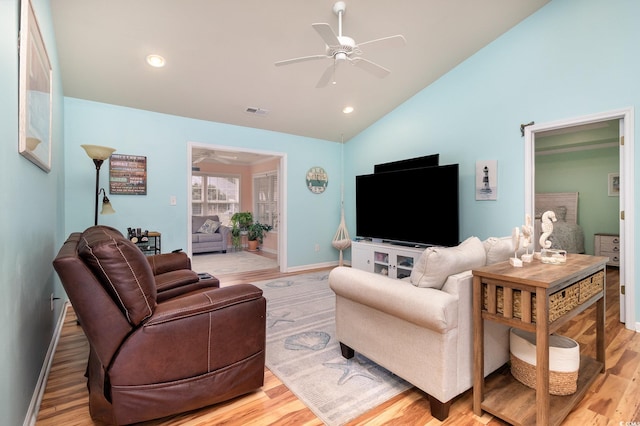 living area featuring baseboards, visible vents, a ceiling fan, and light wood-style floors