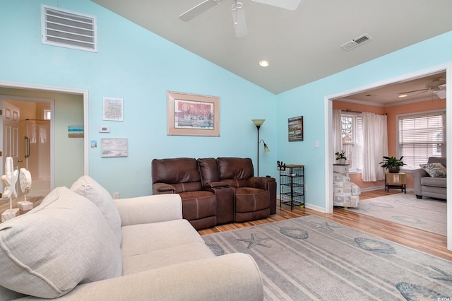 living area with baseboards, light wood-style floors, visible vents, and ceiling fan