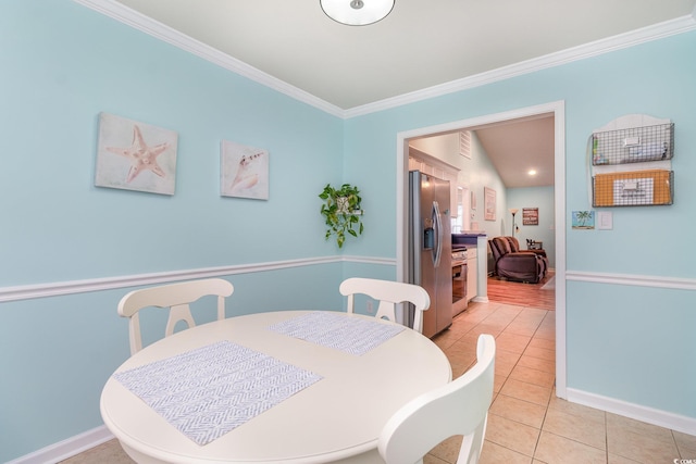 dining area featuring light tile patterned floors, baseboards, and ornamental molding