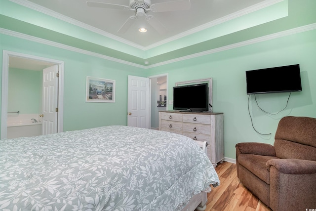 bedroom featuring recessed lighting, a raised ceiling, light wood-style flooring, and crown molding