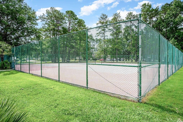 view of sport court featuring a lawn and fence