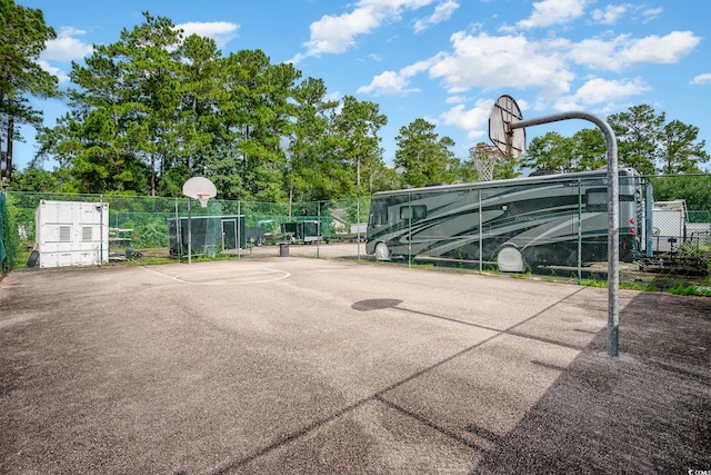 view of basketball court featuring community basketball court and fence