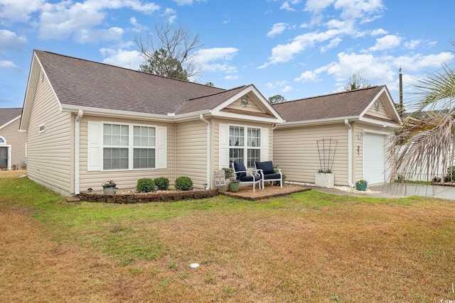 ranch-style home featuring a garage, a patio, roof with shingles, and a front yard