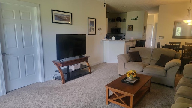 living area featuring light colored carpet and baseboards