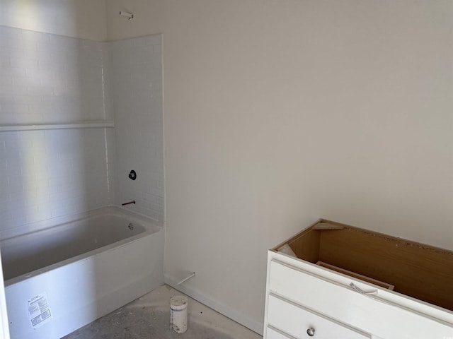 bathroom with shower / tub combination and concrete flooring