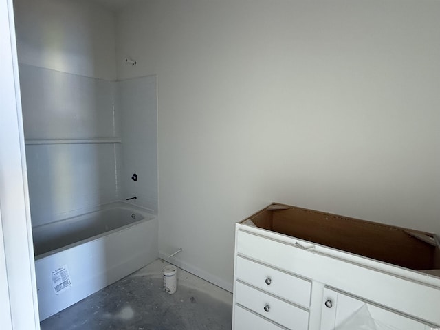 full bathroom with unfinished concrete floors and washtub / shower combination