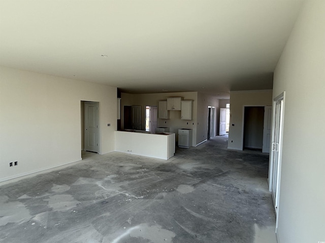 unfurnished living room featuring unfinished concrete flooring