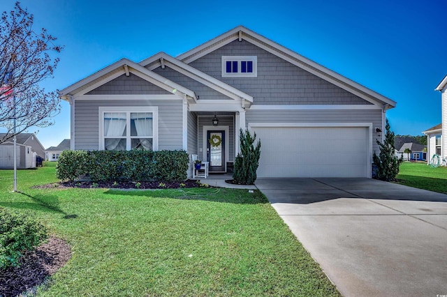 craftsman-style home with driveway, an attached garage, and a front yard