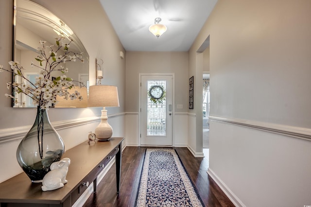 entryway featuring baseboards and dark wood-style flooring