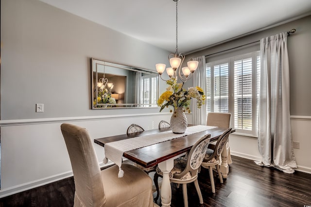 dining space featuring baseboards, an inviting chandelier, and dark wood-style flooring