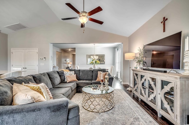 living area with dark wood-style floors, visible vents, ceiling fan with notable chandelier, and vaulted ceiling