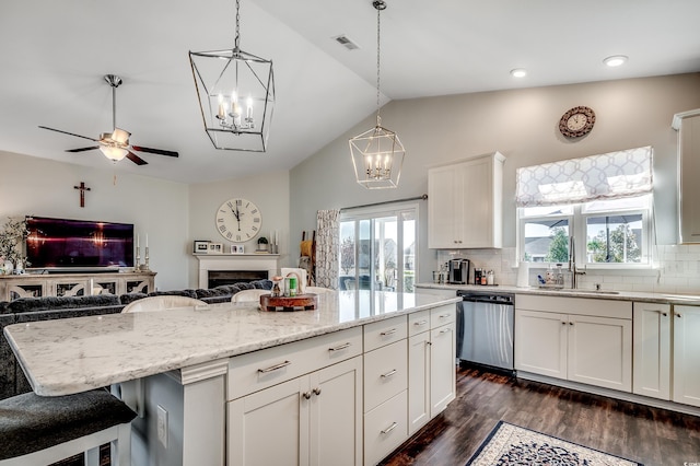 kitchen featuring tasteful backsplash, visible vents, open floor plan, dishwasher, and dark wood-style floors