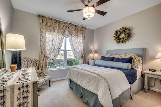 carpeted bedroom with baseboards and ceiling fan