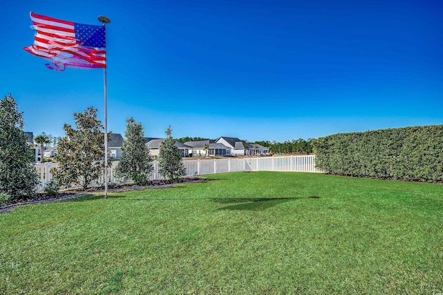 view of yard with a residential view and fence