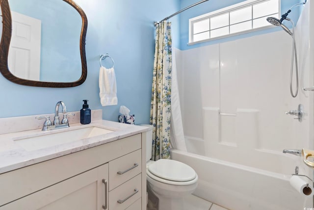 bathroom with vanity, shower / tub combo, and toilet