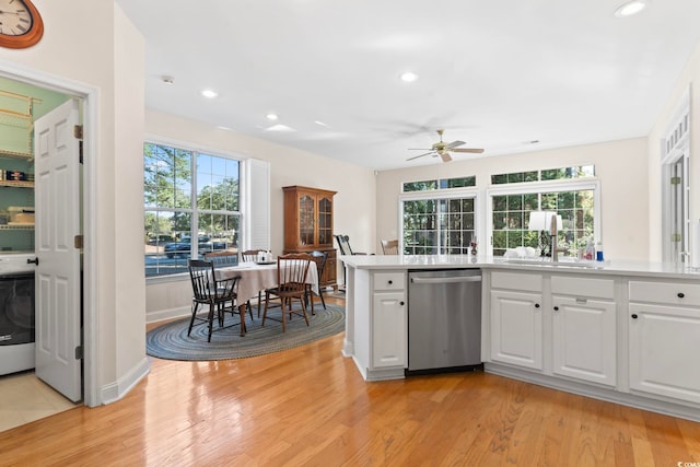 kitchen featuring dishwasher, light wood-style floors, and white cabinetry