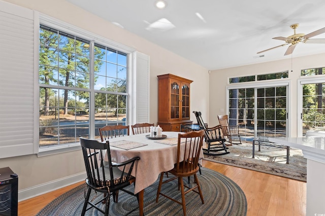 dining space with ceiling fan, plenty of natural light, and wood finished floors