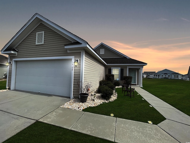 view of front of house featuring a garage, driveway, and a front yard