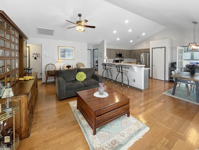 living room with visible vents, lofted ceiling, recessed lighting, light wood-style floors, and a ceiling fan