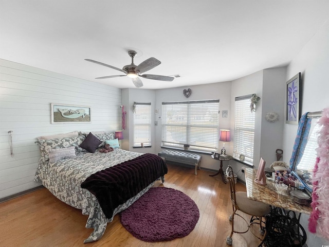 bedroom with visible vents, wood finished floors, and a ceiling fan