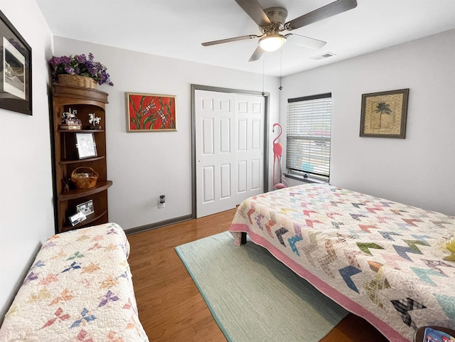 bedroom featuring visible vents, wood finished floors, and a ceiling fan