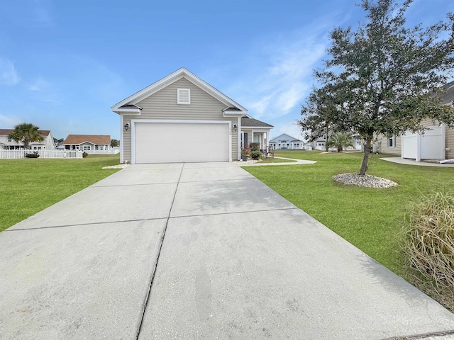 view of front of house featuring a front yard, concrete driveway, and a garage