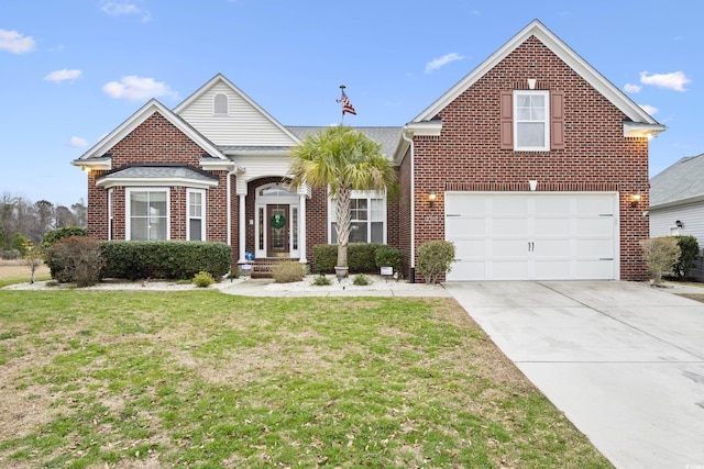 traditional home with brick siding, an attached garage, concrete driveway, and a front yard