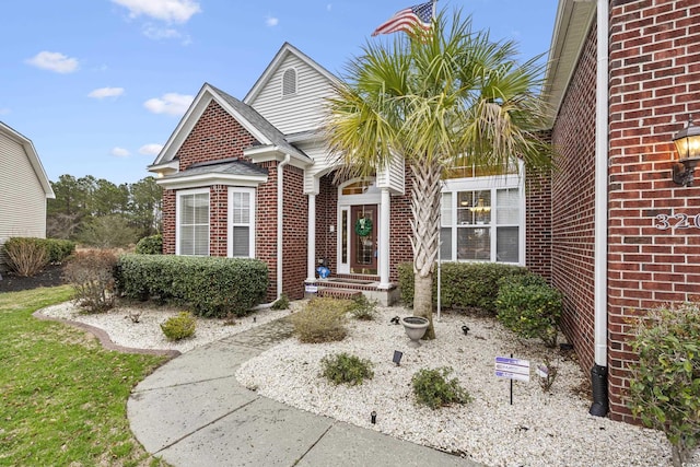 view of front of home featuring brick siding