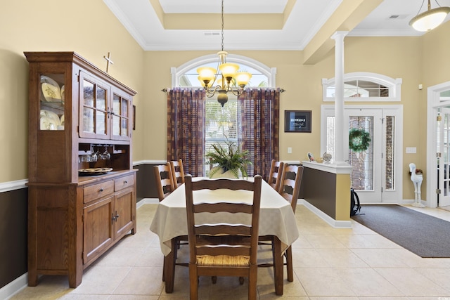 dining area featuring light tile patterned floors, a tray ceiling, a notable chandelier, and ornamental molding