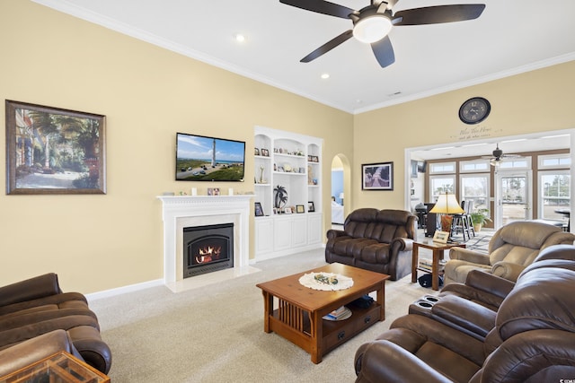 living area with built in features, a fireplace with flush hearth, carpet, and crown molding