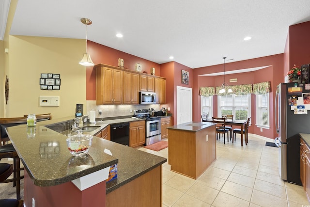 kitchen featuring a center island, appliances with stainless steel finishes, a peninsula, light tile patterned flooring, and a sink