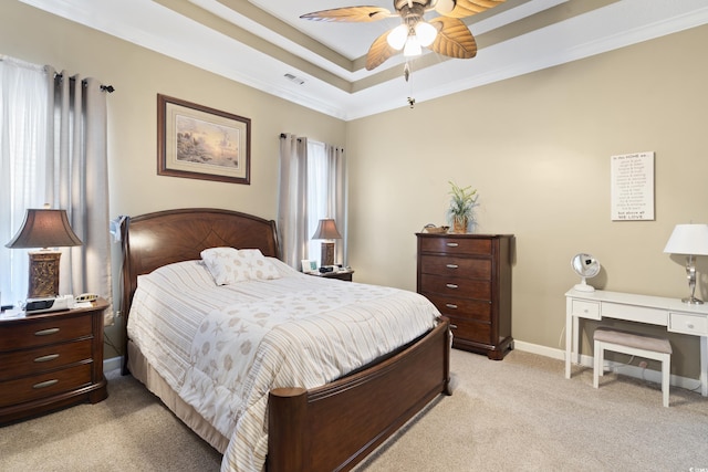 bedroom featuring visible vents, ornamental molding, baseboards, a raised ceiling, and light colored carpet