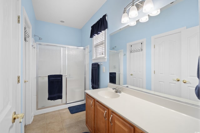 full bathroom with tile patterned flooring, vanity, and a stall shower