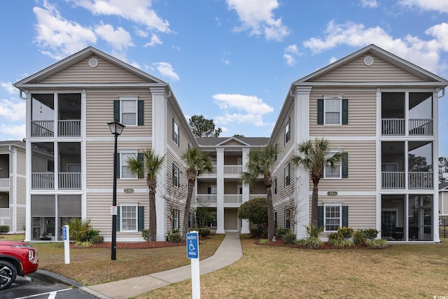 242 Sun Colony Blvd Unit 203, Longs, SC 29568 - view of building exterior with uncovered parking