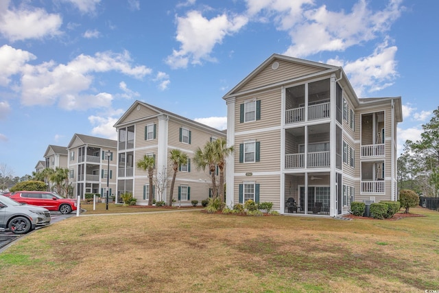 242 Sun Colony Blvd Unit 203, Longs, SC 29568 - view of building exterior with uncovered parking