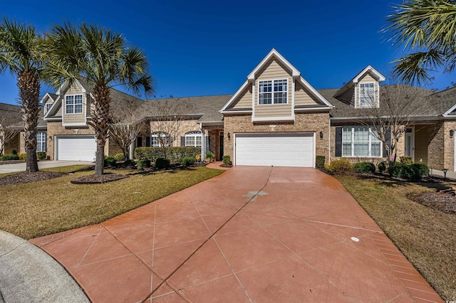 view of front facade with a front lawn, a garage, brick siding, and driveway