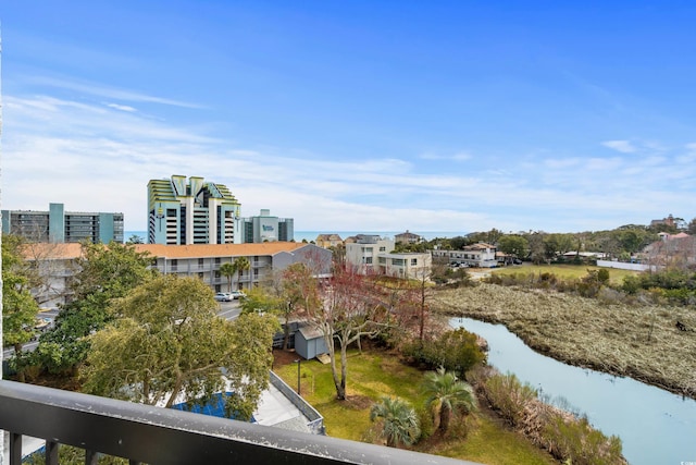 exterior space with a city view and a water view